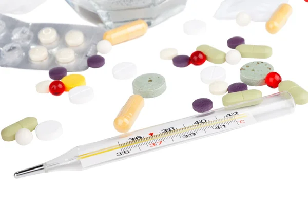 Drugs and thermometer Royalty Free Stock Photos