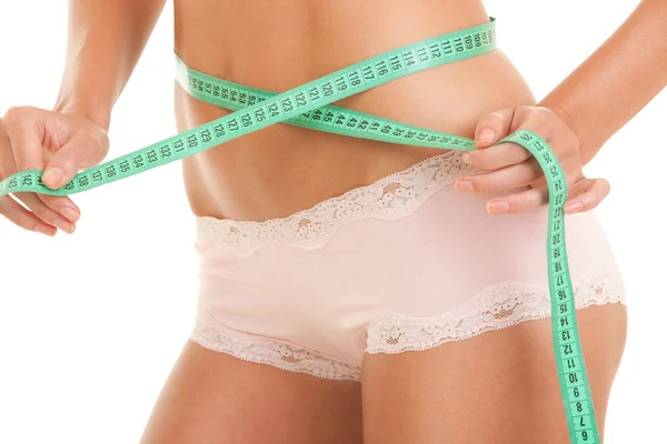 Athletic woman body with measure tape — Stock Photo, Image