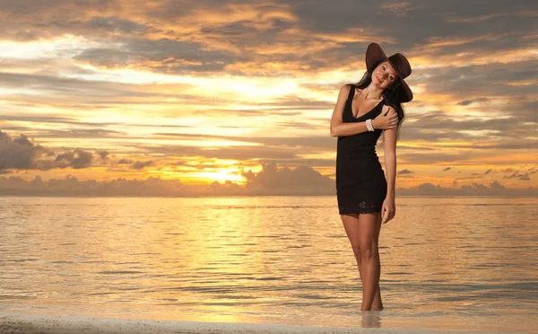 Mode kvinna på havet solnedgång bakgrunden — Stockfoto
