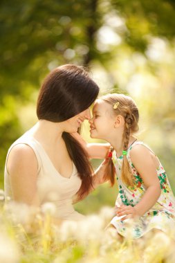 Mother and daughter in the park clipart