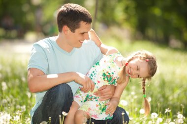 Father and daughter in the park clipart