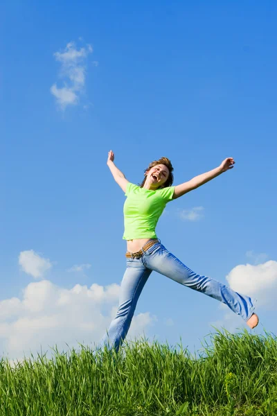 Expressive young woman is jumping — Stock Photo, Image