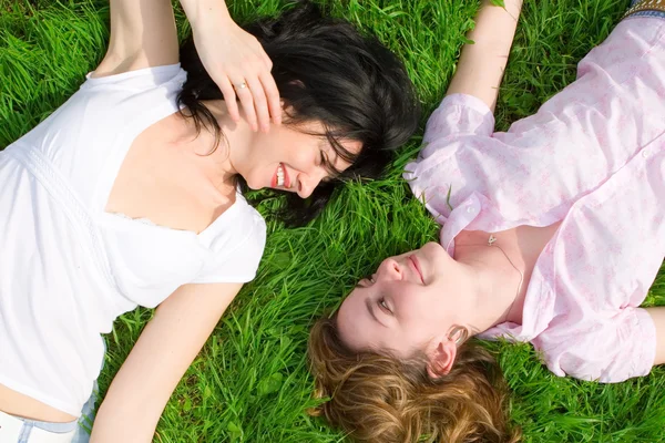 Pretty women rest on the green grass — Stock Photo, Image