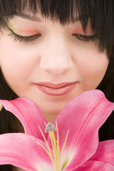 Young pretty woman with lily flower — Stock Photo, Image