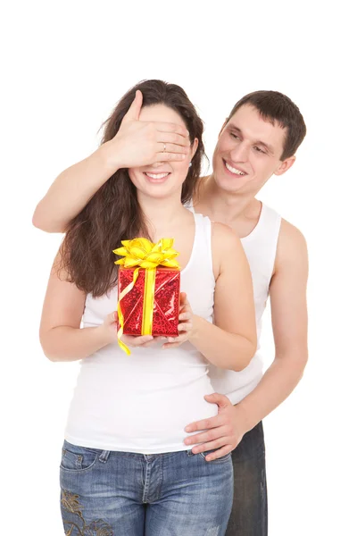 Young man presents gift to woman, on white background — Stock Photo, Image