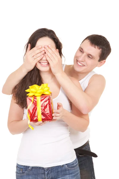 Young man presents gift to woman, on white background — Stock Photo, Image