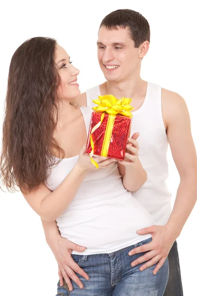 Mladý muž představuje dárek pro ženu, na bílém pozadí — Stock fotografie