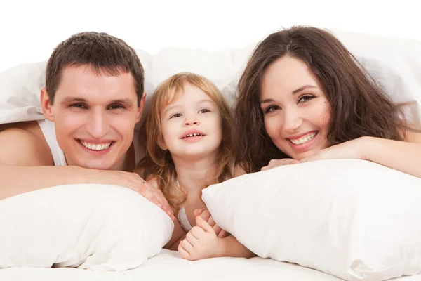 Happy family, mother, father and daughter resting on the white b — Stock Photo, Image