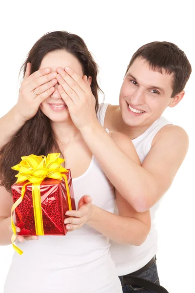 Young man presents gift to woman, on white background Stock Image