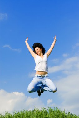 Happy young woman is jumping clipart