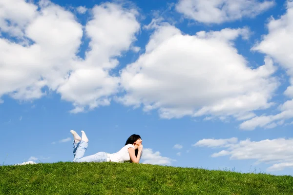 Hübsche Frau ruht sich auf dem grünen Gras aus — Stockfoto