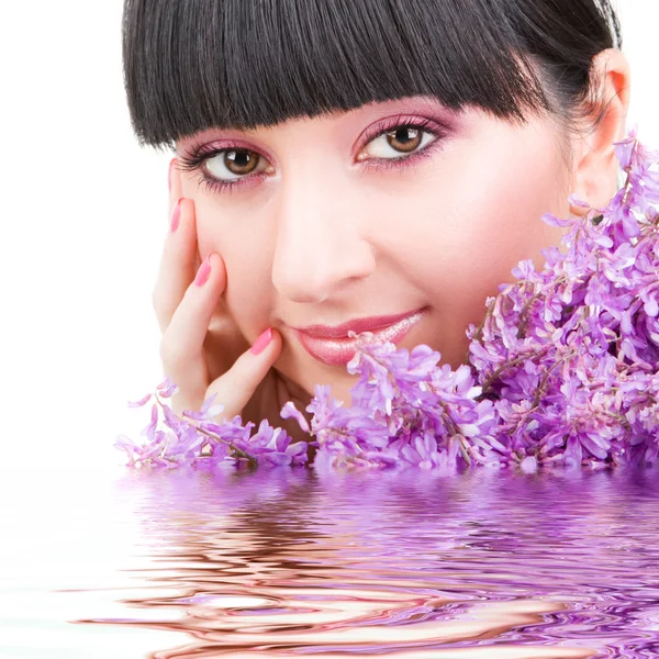 Young woman with lilac flowers — Stock Photo, Image