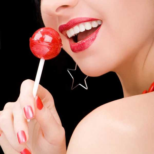 Sweet woman with candy on black background — Stock Photo, Image