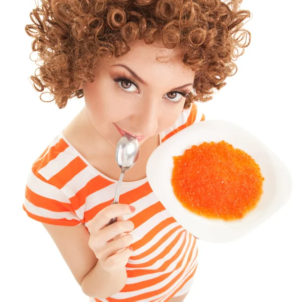 Веселая женщина ест икру на белом фоне — стоковое фото