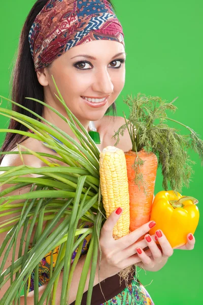 Pretty girl with vegetables on the green background — Stock Photo, Image
