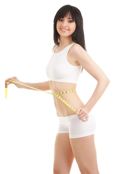 Happy young woman with measure tape — Stock Photo, Image