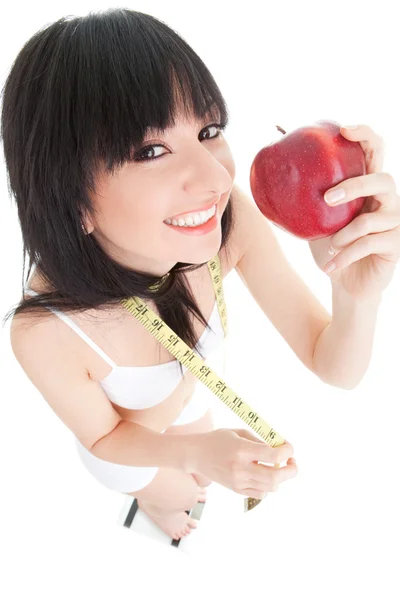 Spaßfrau mit rotem Apfel und Maßband auf der Glaswaage — Stockfoto