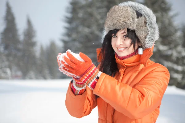 Happy girl playing with snow in the winter landscape — Stock Photo, Image
