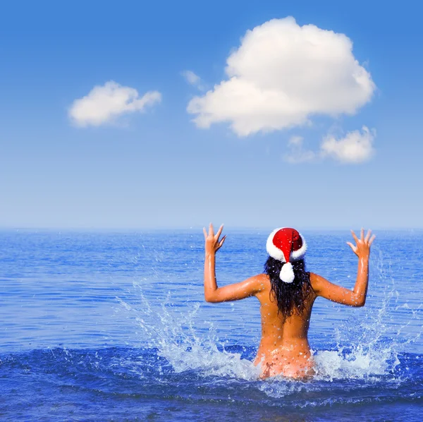 Young sexy santa girl in the sea — Stock Photo, Image