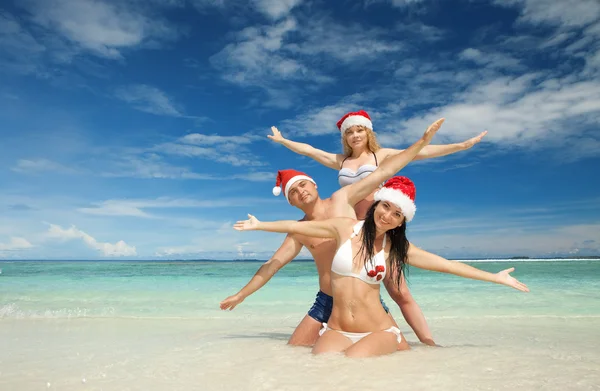 Ευτυχής φίλους σε καπέλα santa στην παραλία. διακοπές Χριστουγέννων — Φωτογραφία Αρχείου