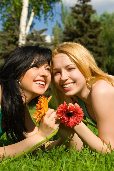 Pretty women rest in the park with flowers — Stock Photo, Image