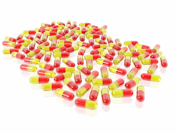 Pílulas vermelhas e amarelas no fundo branco — Fotografia de Stock