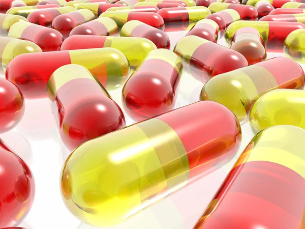 Czerwone i żółte tabletki na białym tle — Zdjęcie stockowe
