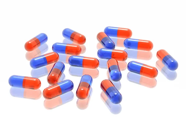 Pilules rouges et bleues sur fond blanc — Photo
