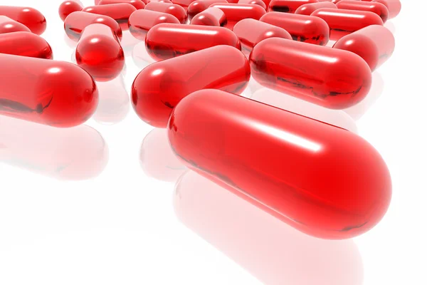 Pilules rouges sur fond blanc — Photo