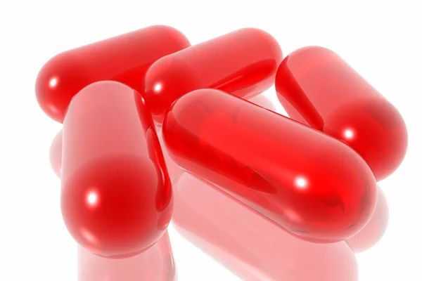 Píldoras rojas sobre fondo blanco — Foto de Stock