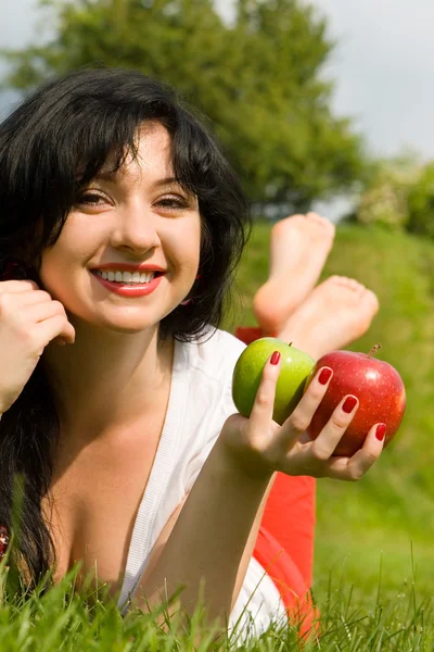 Pretty woman with apples on the summer glade — Stock Photo, Image