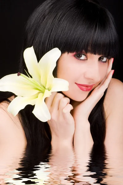 Young woman with lily flower — Stock Photo, Image