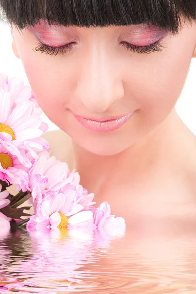 Lovely brunette with pink flowers — Stock Photo, Image