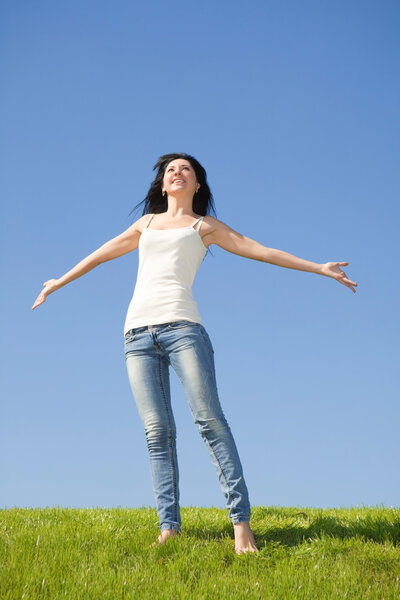 Happy young woman dreams to fly on winds