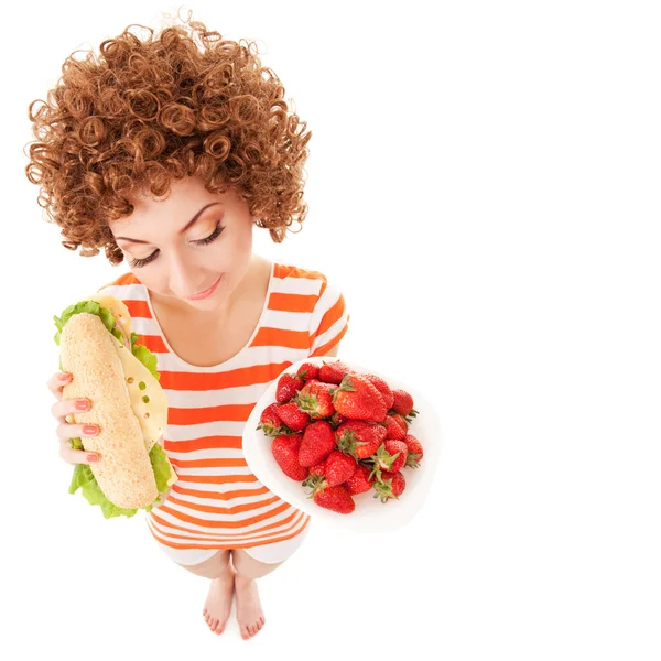 Lustige Frau mit Erdbeere und Sandwich auf weißem Hintergrund — Stockfoto
