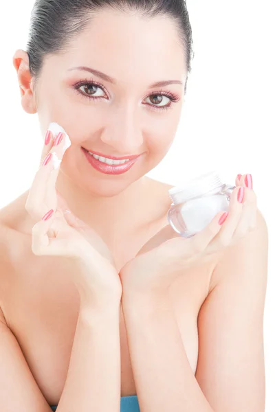 Woman applying cream to her face on the white background — Stock Photo, Image
