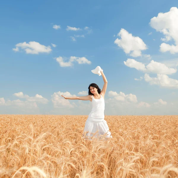 Young woman in golden wheat — Stock Photo, Image