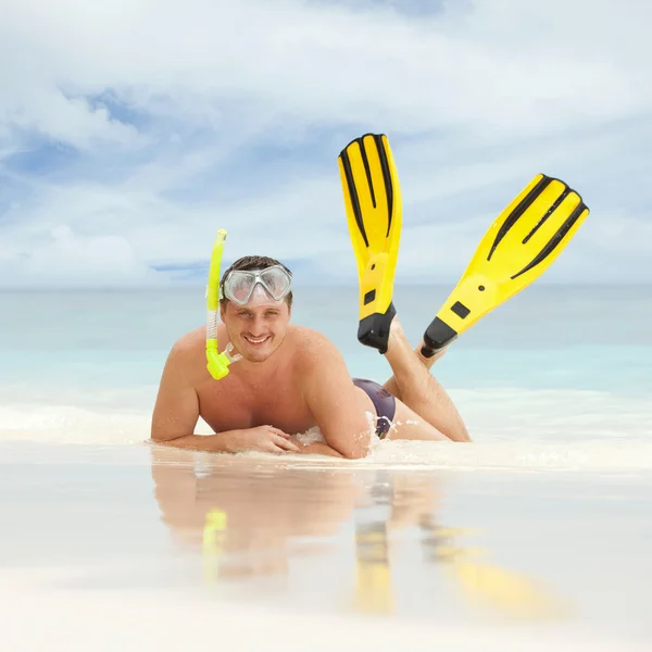 stock image Happy man with snorkeling equipment on the beach