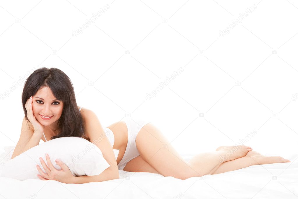 Sexy woman lying on the white bed