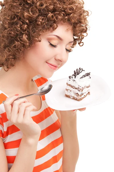 Fun woman eating the cake on the white background — Zdjęcie stockowe
