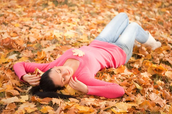 Молода красива жінка відпочиває в осінньому парку — стокове фото