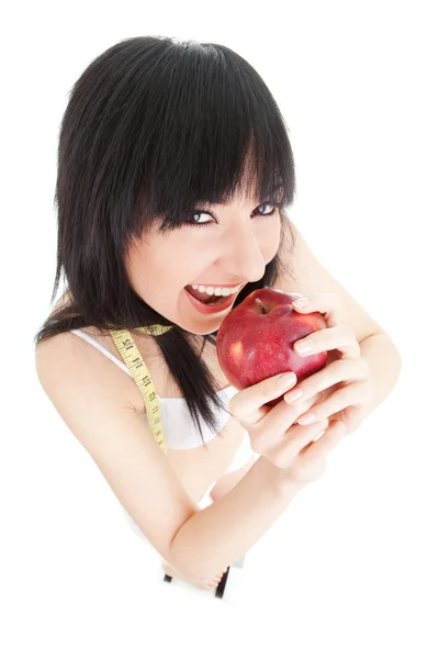 Fun woman with red apple and measure tape on the glass scales — Stock Photo, Image