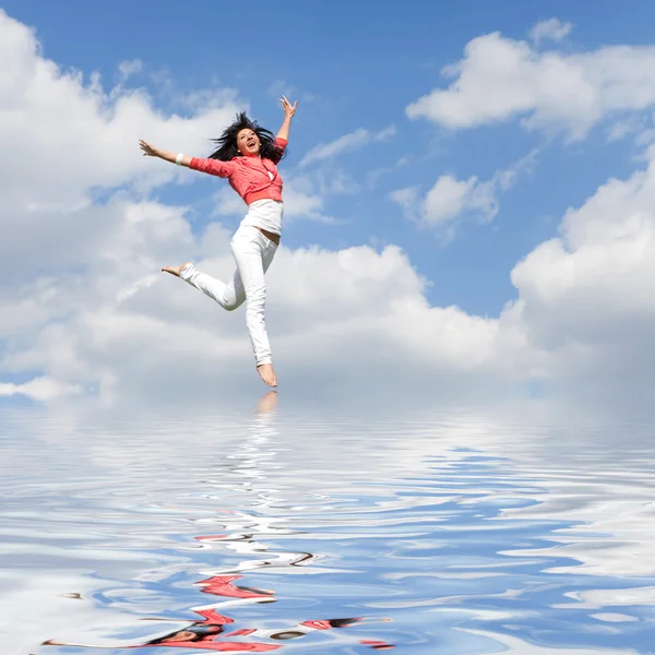 Pretty young woman jumping on water — Stock Photo, Image