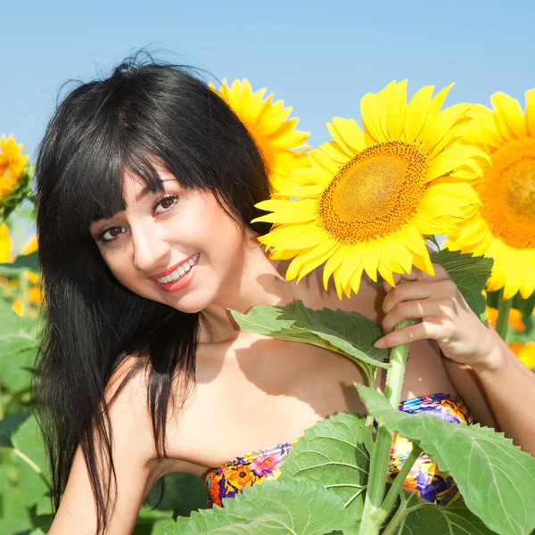 Fun woman in the field of sunflowers — Stock Photo, Image
