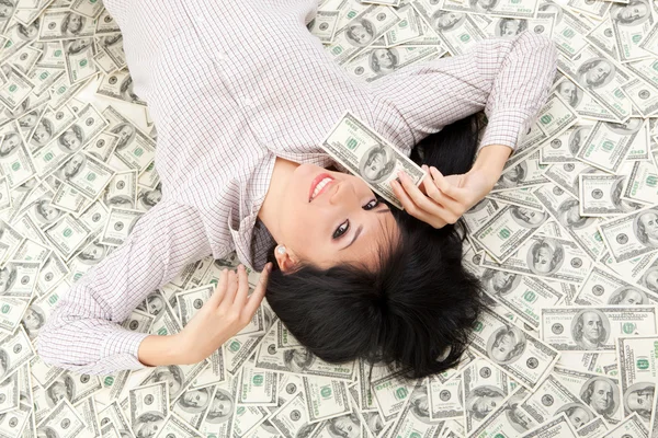 stock image Young business woman resting upon money