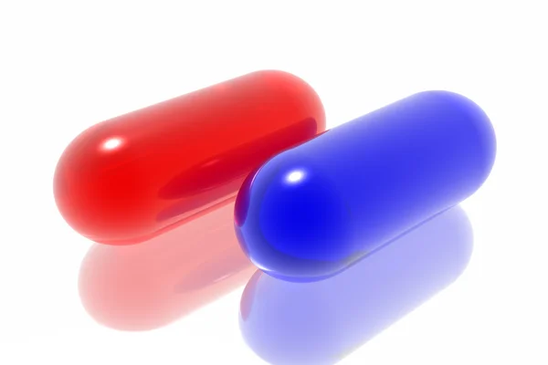 Pílulas vermelhas e azuis no fundo branco — Fotografia de Stock