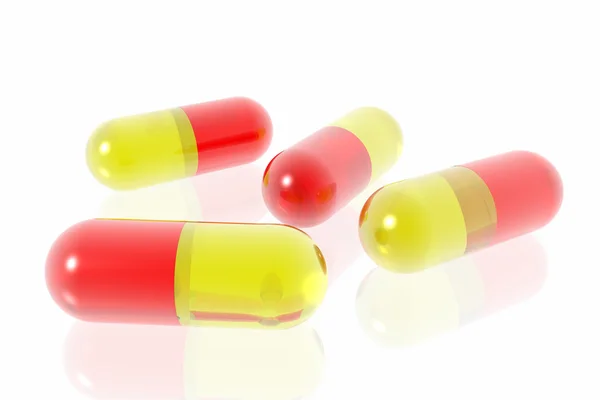 Röda och gula piller på vit bakgrund — Stockfoto