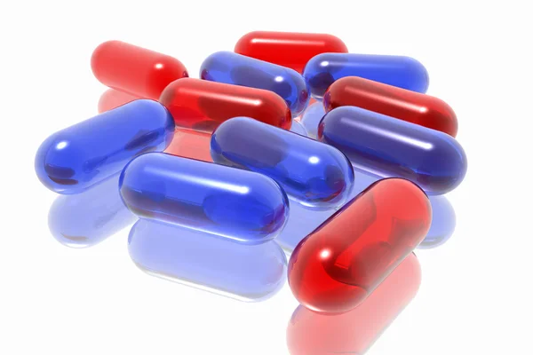 Червоні і сині таблетки на білому тлі — стокове фото