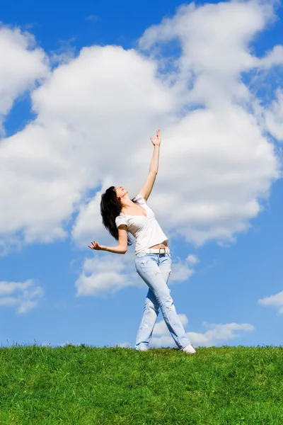 Expressive woman dancing on green grass — Stock Photo, Image