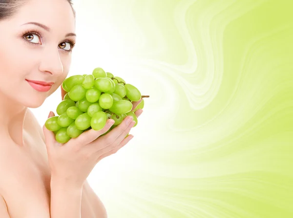 Pretty woman with green grape — Stock Photo, Image